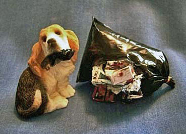 dollhouse basset hound tearing up trash bag