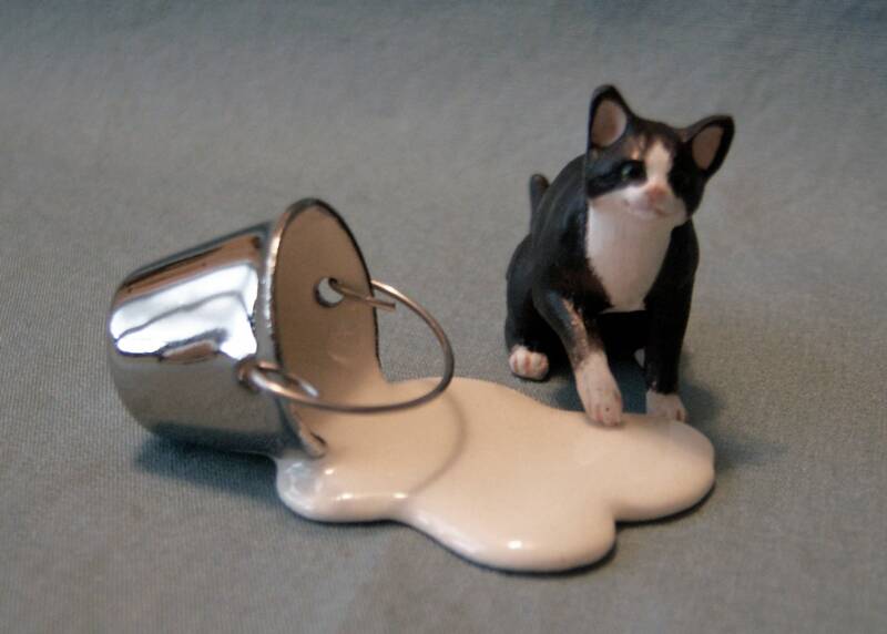 black and white dollhouse cat with spilled milkpail