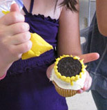 child making a hello cupcake sunflower
